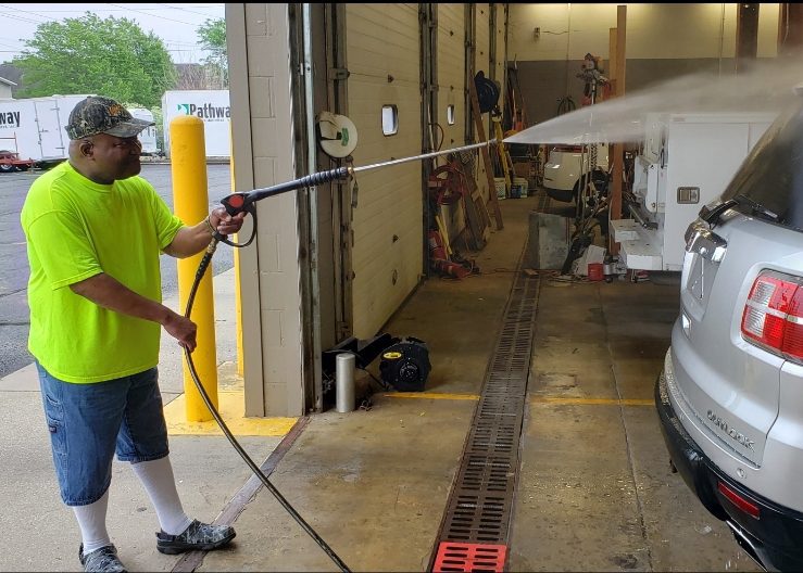 Day program member at the washing car.